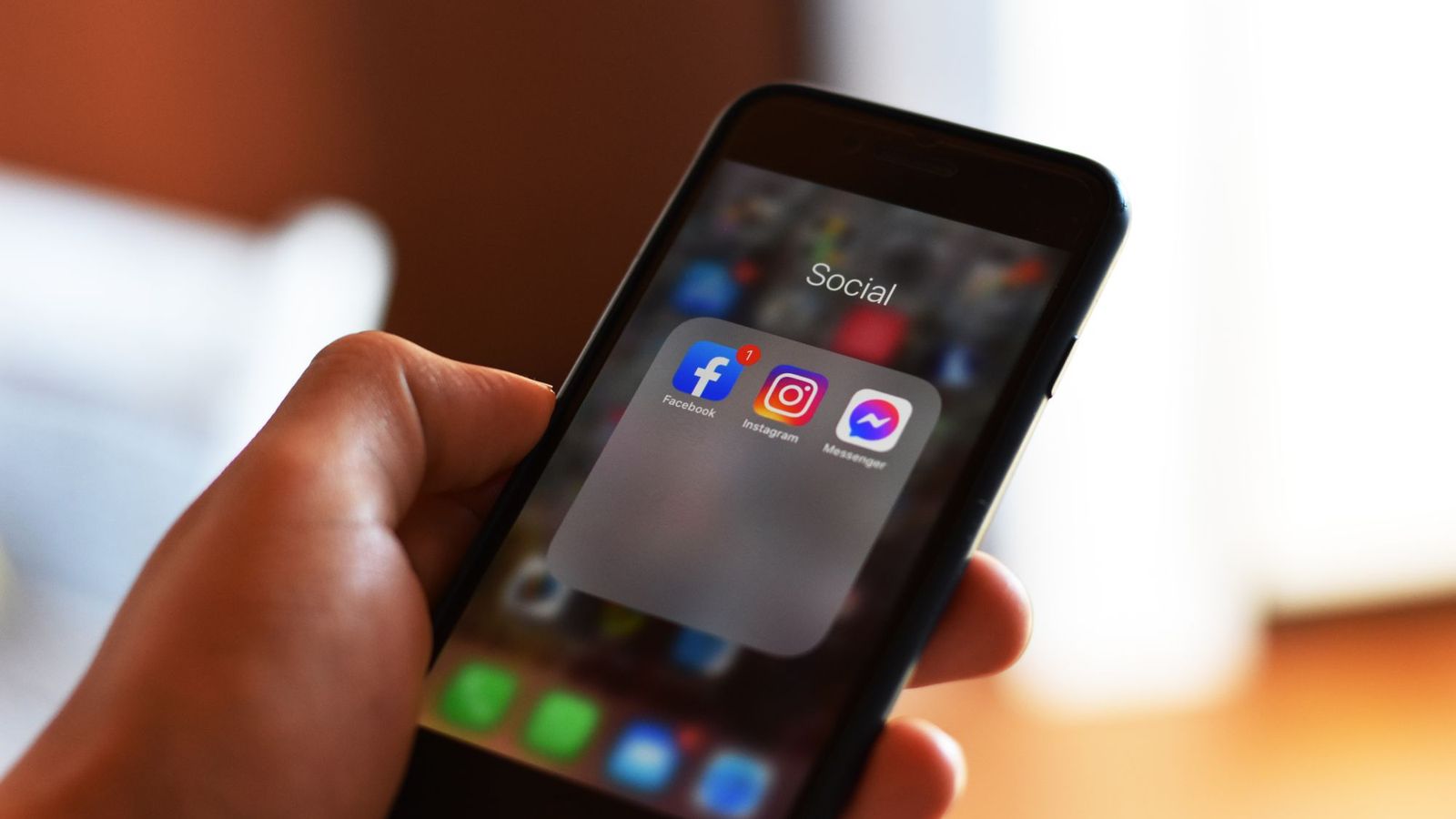 Phone showing social media apps — compliant marketing for CBD and vape brands UK